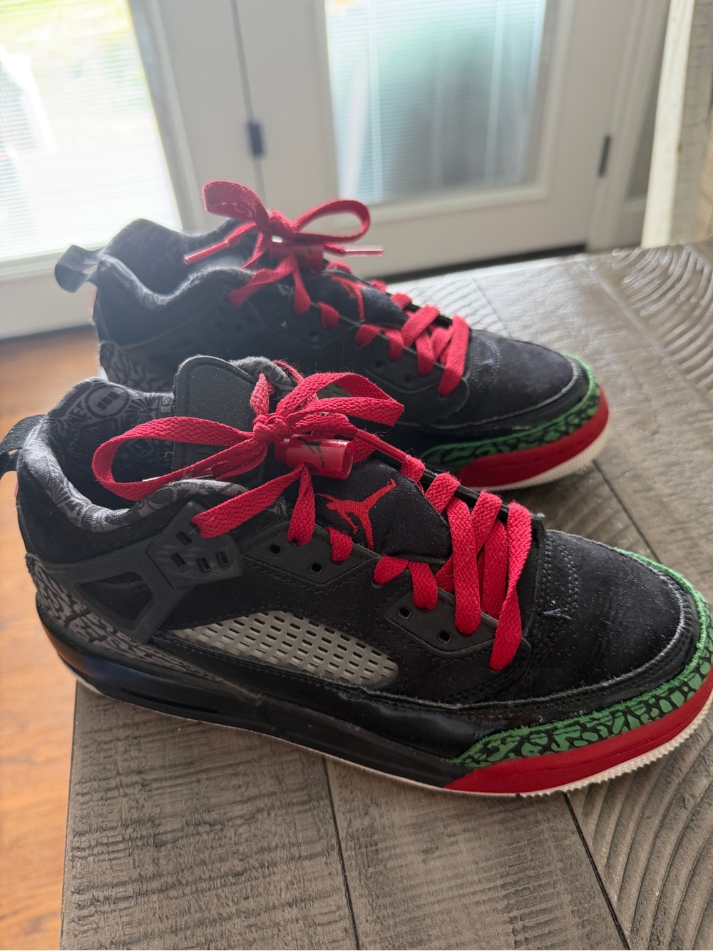 Jordan Kids Black Sneakers with Red Laces and Green Trim.